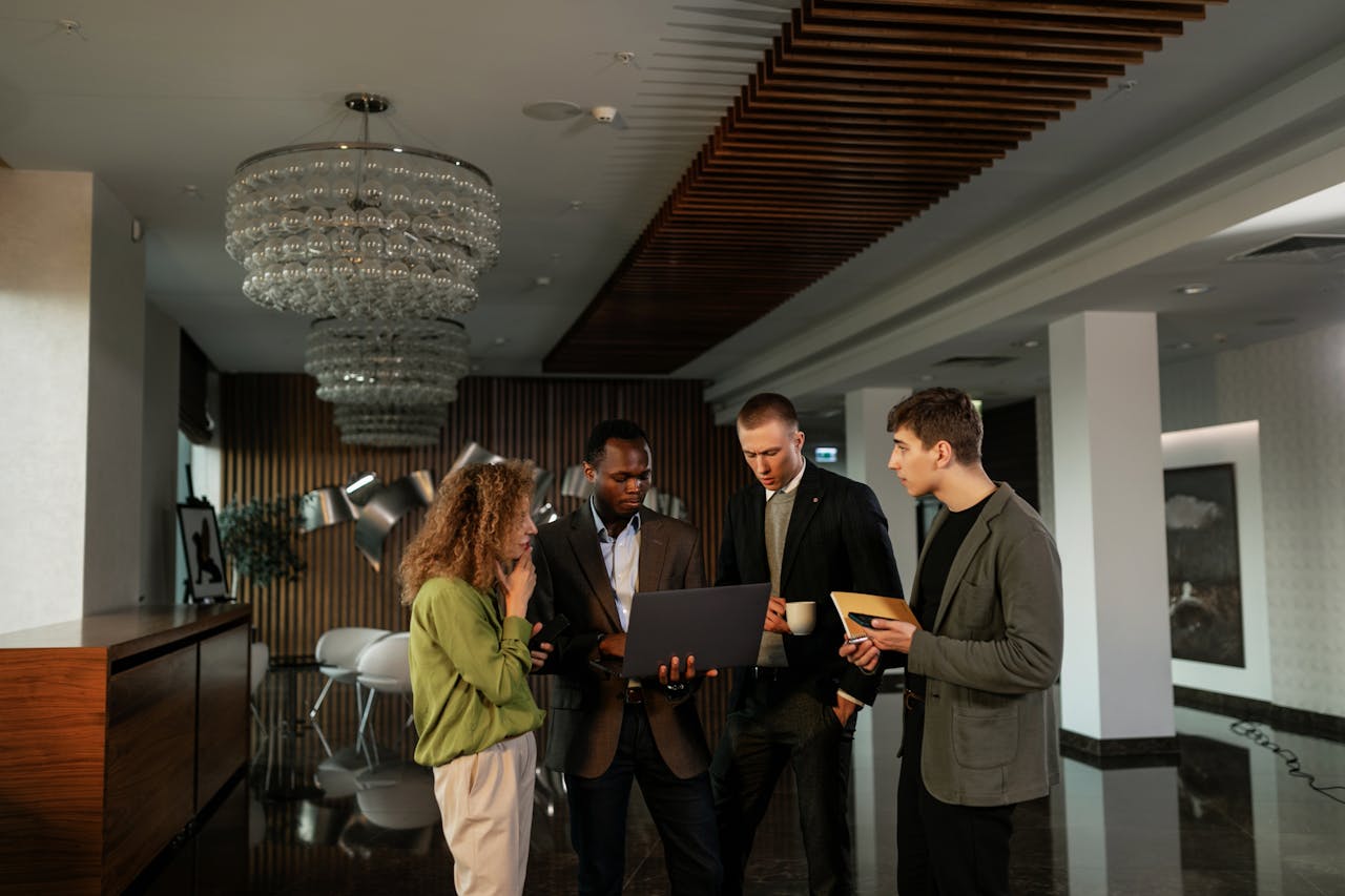 Group of diverse professionals discussing ideas in a modern office setting.